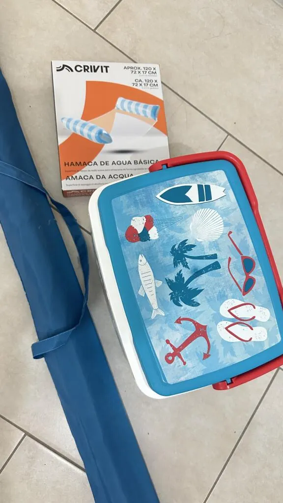 Ice cooler, beach umbrella and floater